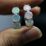 ‘Dottie’ Three Round Opal Huggie Earrings – held in fingers